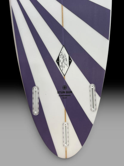 Arakawa Stun Gun 6'6 surfboard – tail and fin boxes close-up, purple sunburst spray